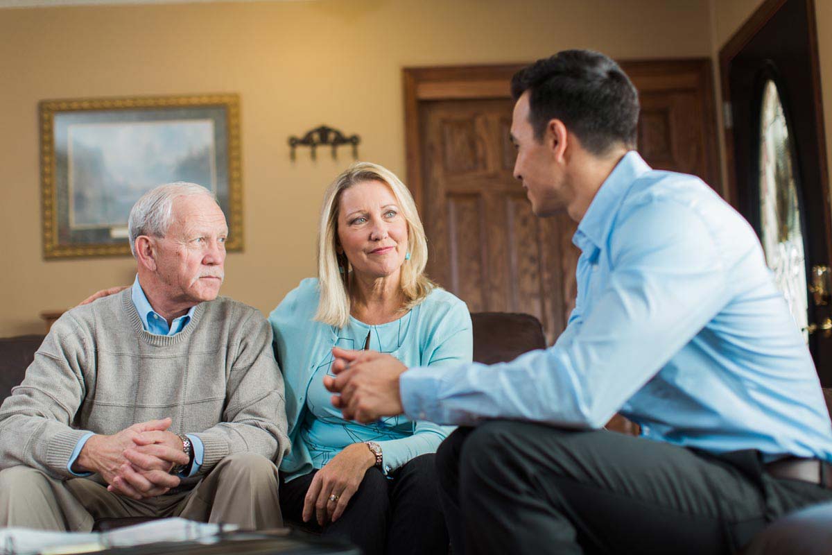 Daughter and senior interviewing a caregiver