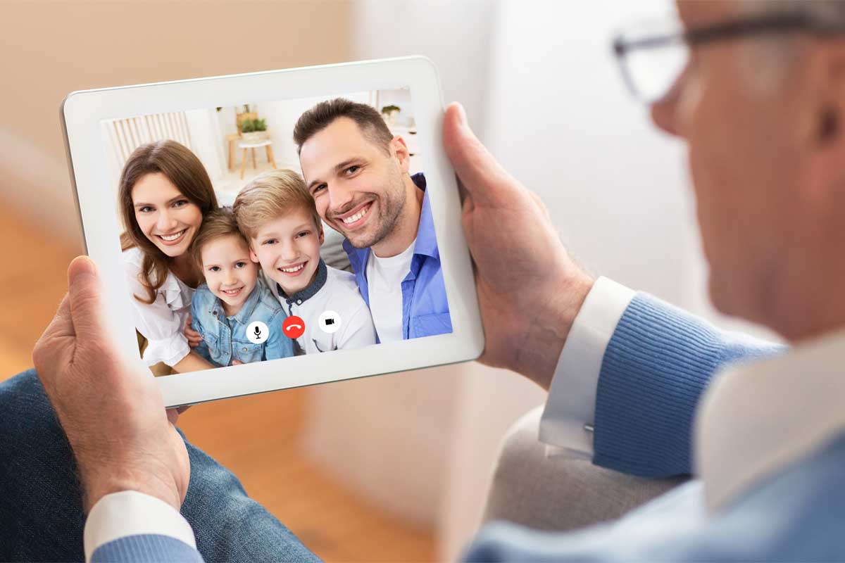 Senior having a skype call with his family