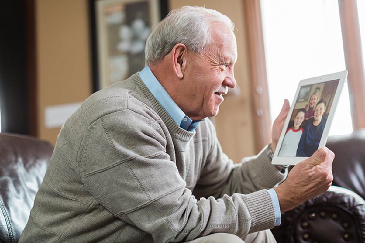 Senior having a conference call with family members