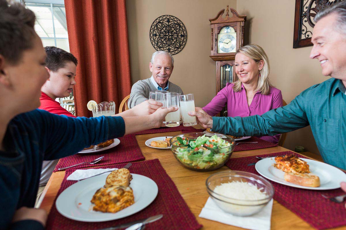 Three generations having dinner at home