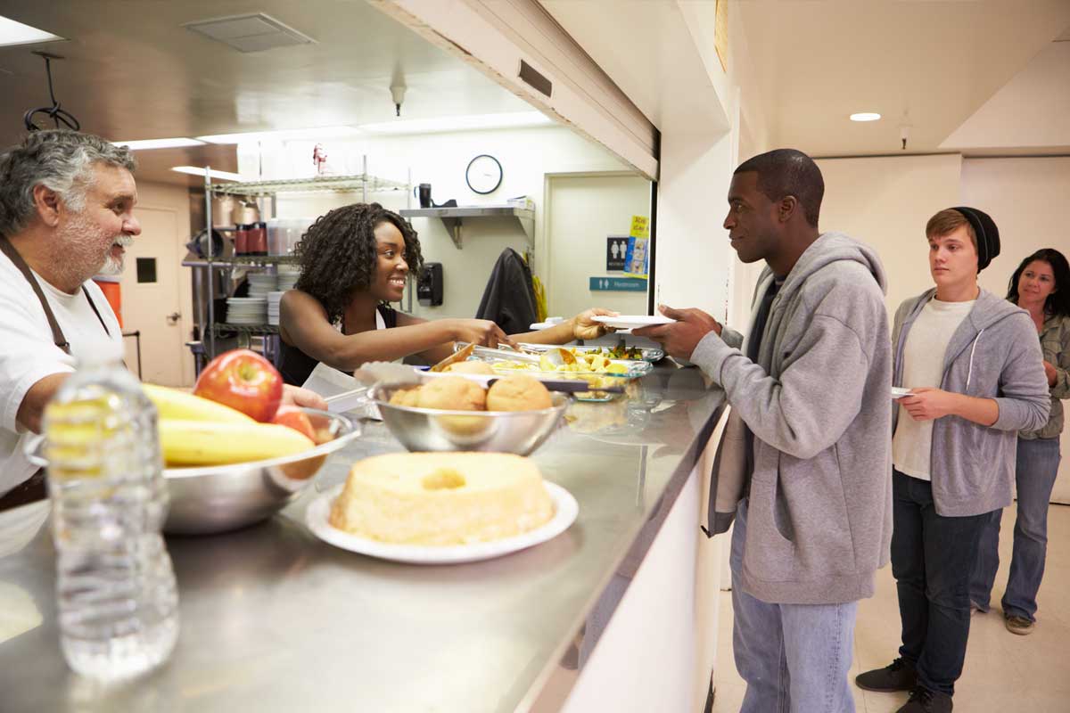 Senior serving soup at a community kitchen