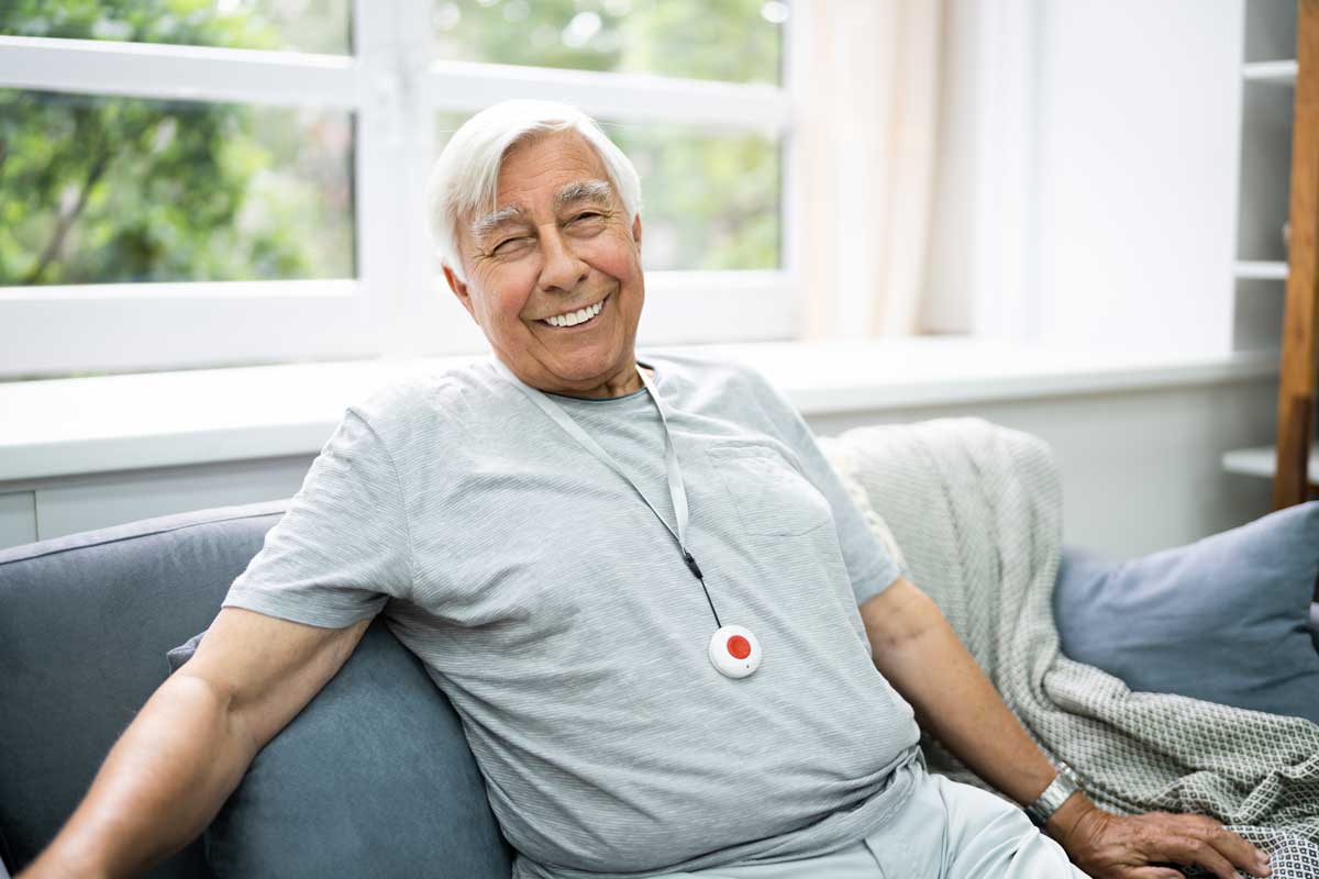 Senior wearing a button for medical emergencies 